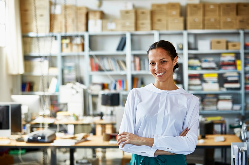 business-woman-standing-with-arms-crossed-in-office-personal-goals