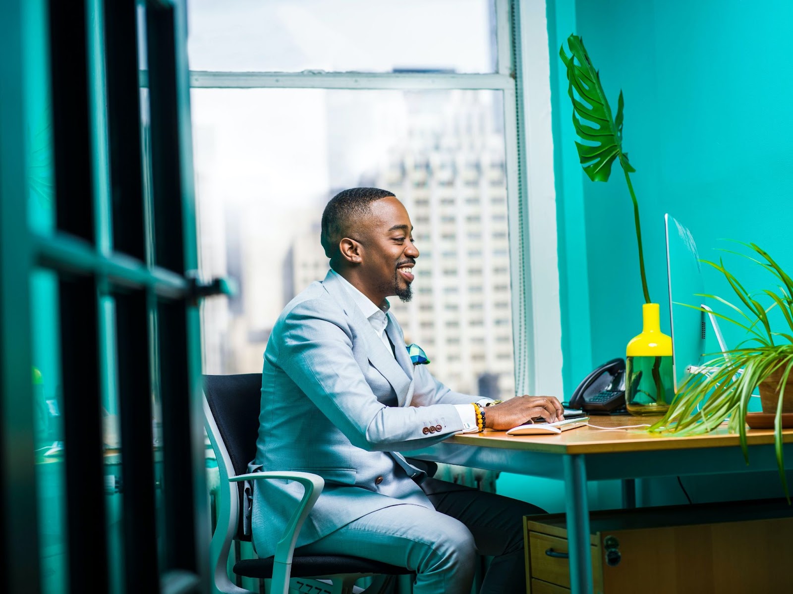 man-working-at-desk-smiling-in-demand-skills