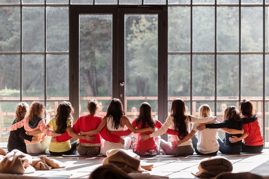 group-of-women-sitting-with-their-hands-linked-together-building-resilience