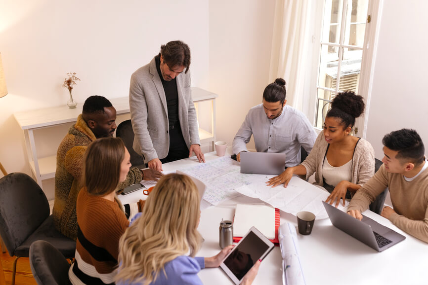 team-sitting-together-around-a-table-discussing-core-values