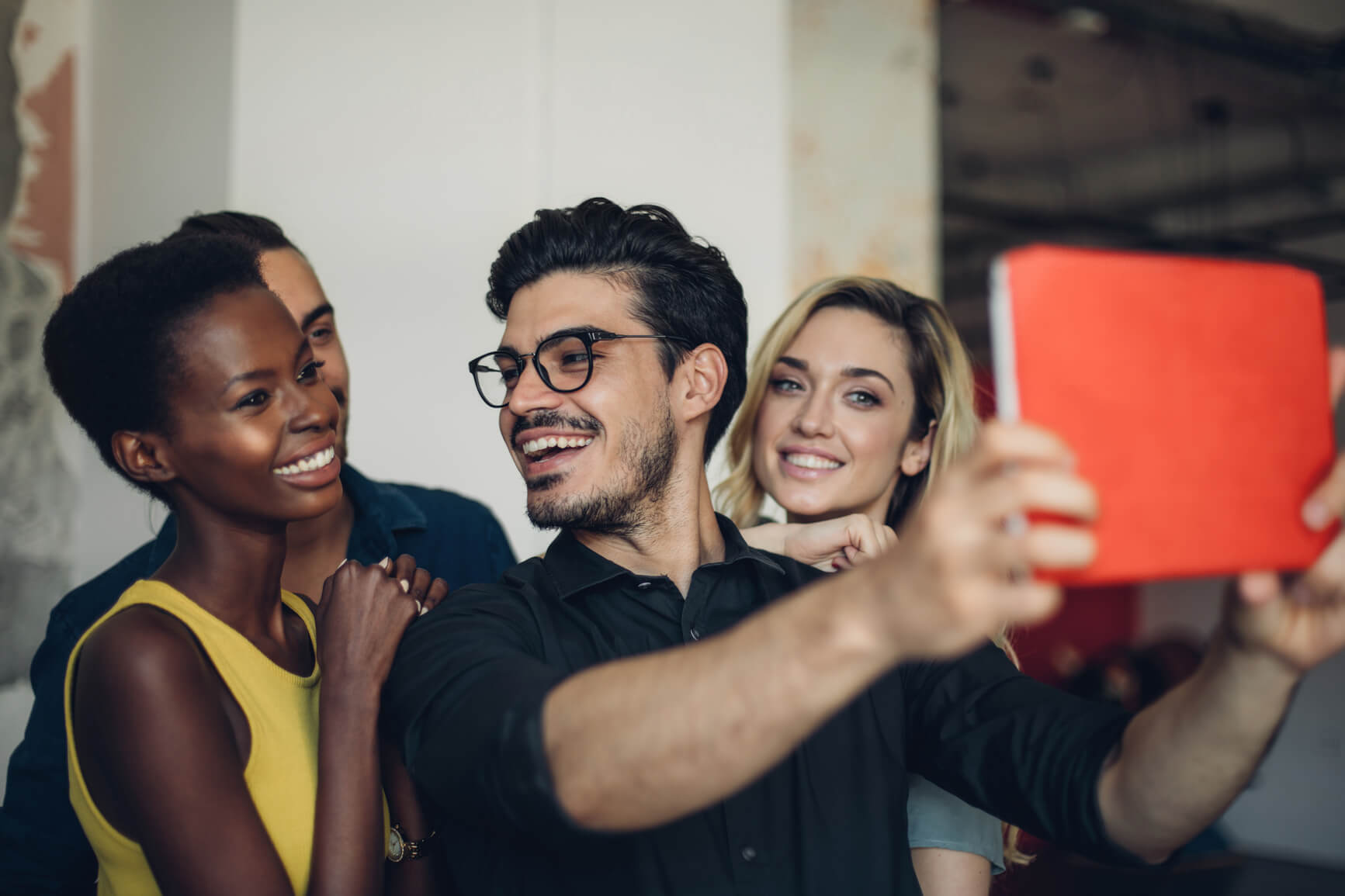 man taking selfie with female coworkers (1)