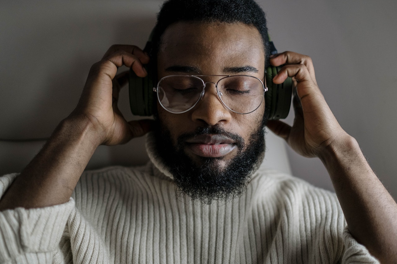 man-putting-on-headphones-and-closing-his-eyes-relaxed-what-is-an-empath