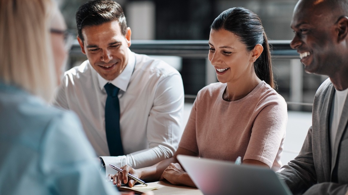 three-employees-laugh-while-others-on-video-new inclusive skills of managers in hybrid