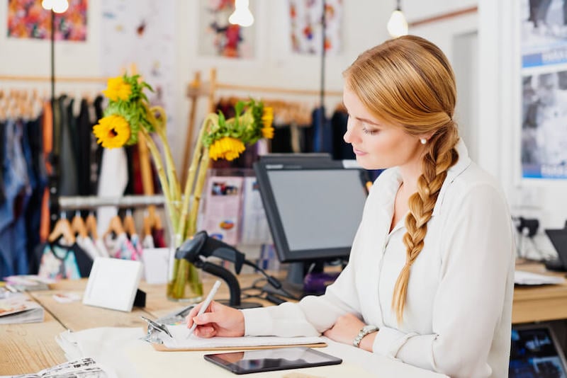 sales_coaching_person with clipboard at desk