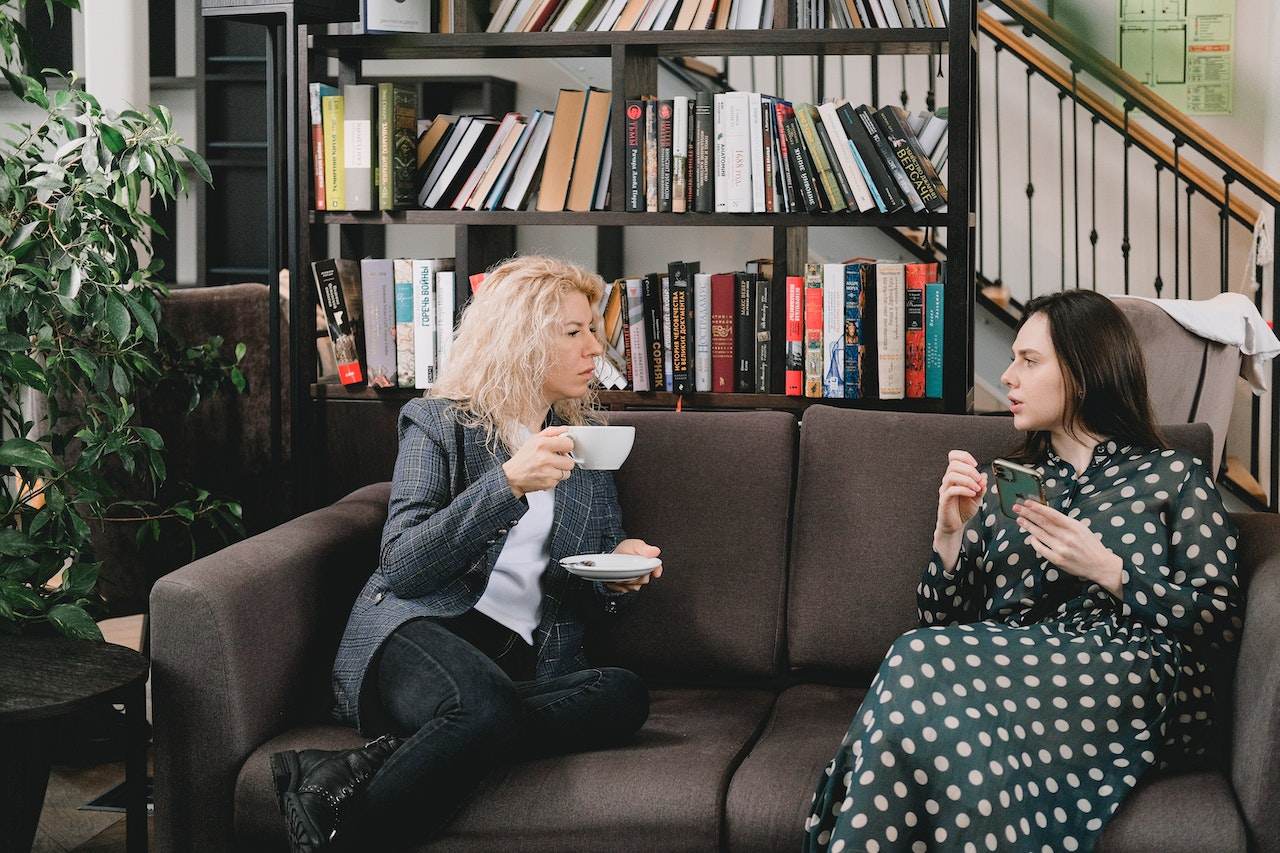 two-coworkers-gossiping-at-break-room-what-is-an-empath