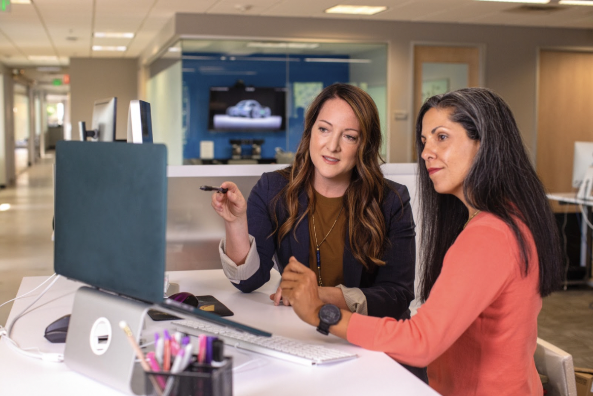 two-women-point-at-computer-career-paths